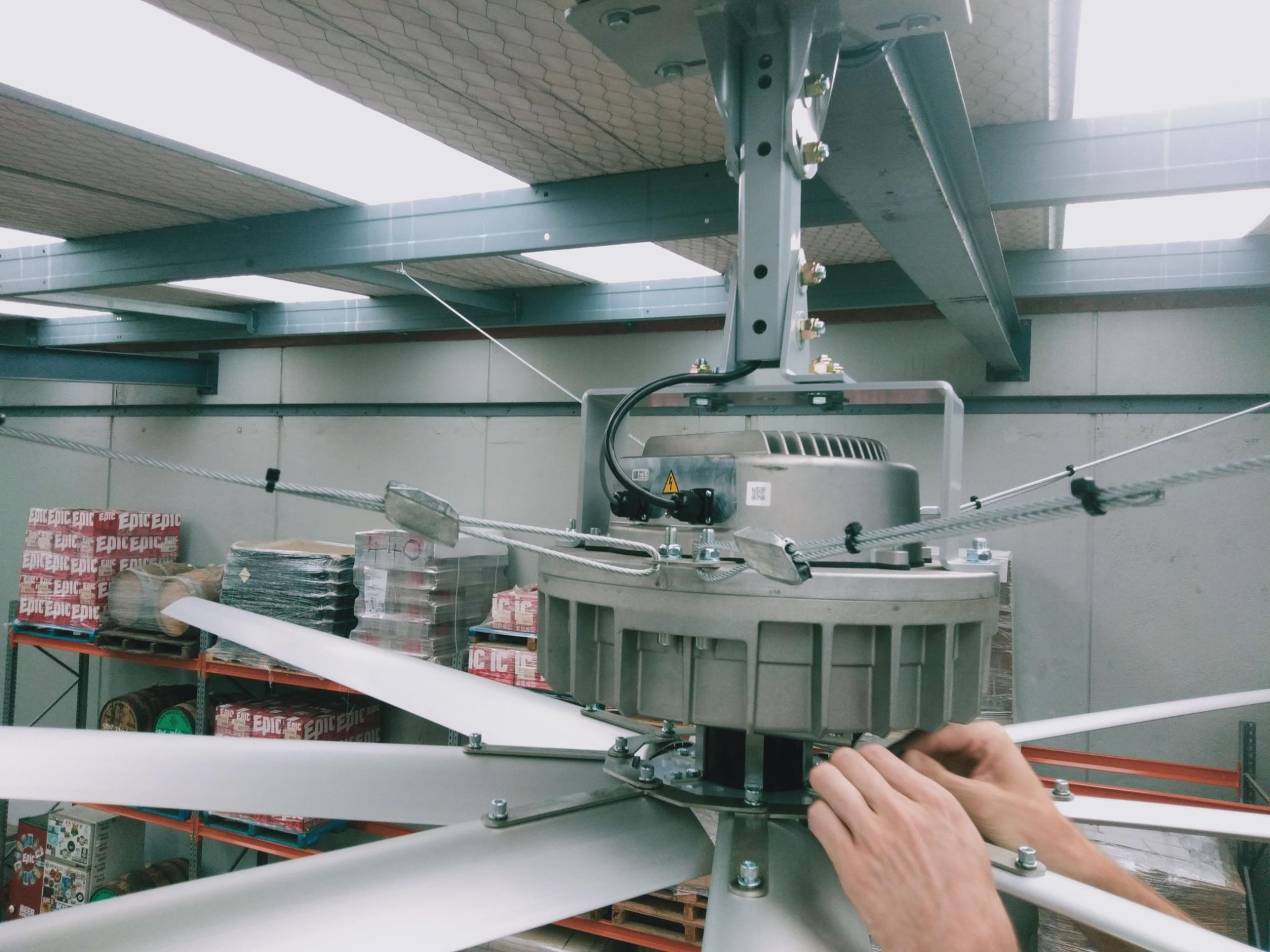 Industrial HVLS fan install in a brewery warehouse